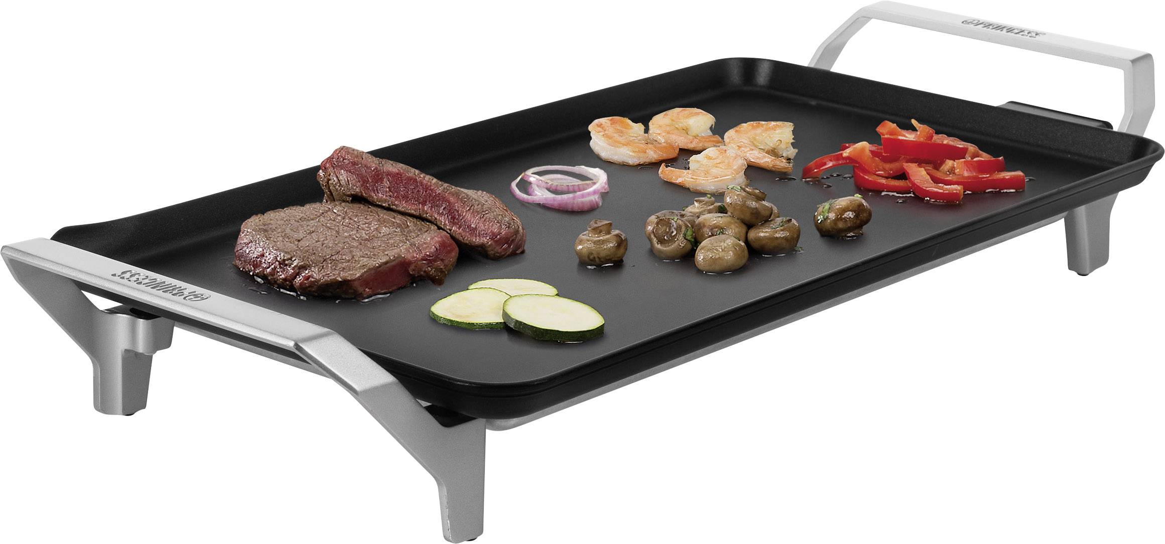 Stolní gril s různými pokrmy: steak, krevety, papriky, houby, cibulové kroužky a cukety na grilovací desce.