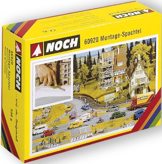 Žlutý obal s nápisem 'NOCH 60920 Modelářský tmel', zobrazující model krajiny pro modelovou železnici a fotografii ruční práce.