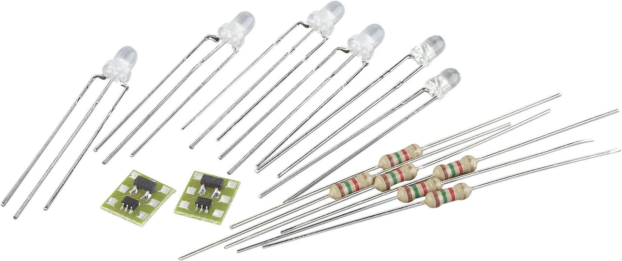 LED diody, rezistory a malé elektronické obvody leží na bílém pozadí. Elektronické komponenty pro obvody a projekty.