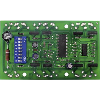 Zelená deska plošných spojů s elektronickými komponenty, včetně odporů, kondenzátorů a DIP přepínače s nápisem 'ON'.