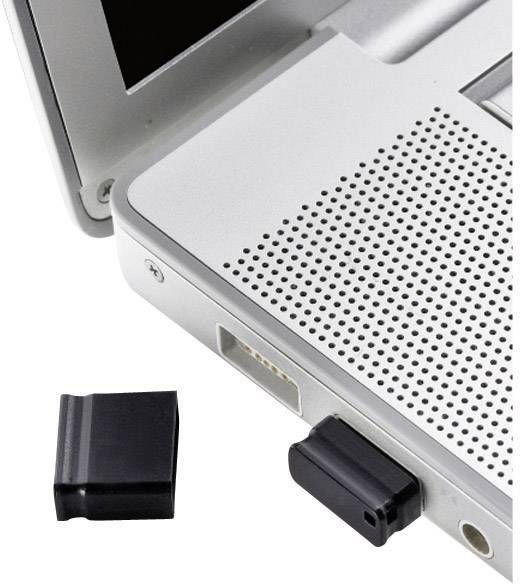Černý USB flash disk je připojen k laptopu. Vedle laptopu leží víčko USB disku na stole.