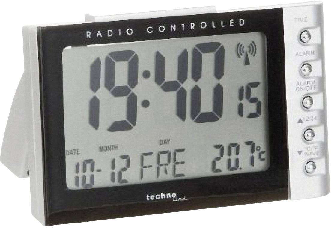 Digitální rádio budík ukazuje 19:40 hodin, 15 sekund. Datum: 10. prosince. Teplota: 20,7°C. Tlačítka pro alarmové funkce jsou viditelná vpravo.