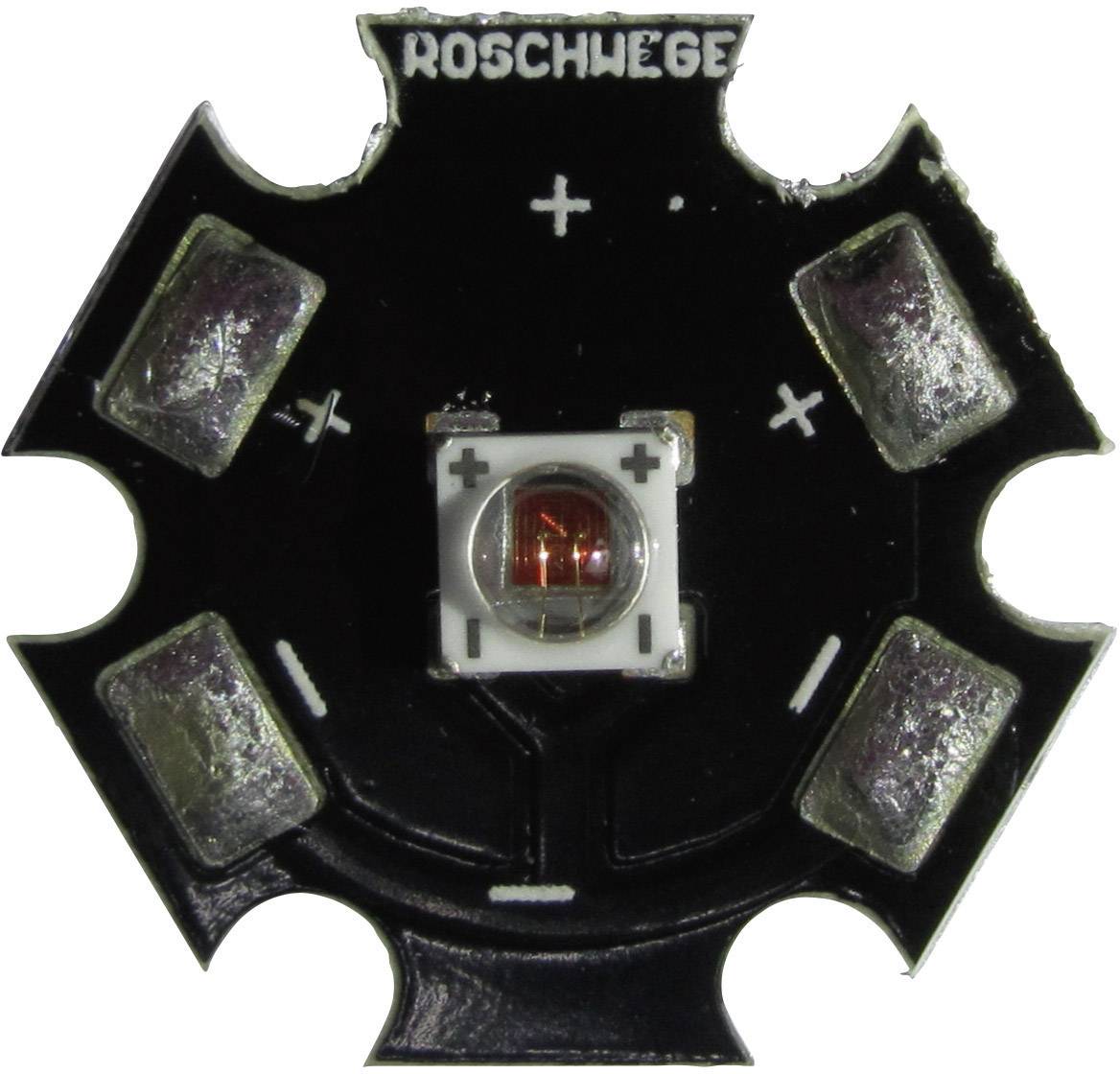 LED prvek na šestiúhelníkovité desce plošných spojů s vyznačenými polaritními symboly (+/-) a nápisem 'ROSCHWEG'.