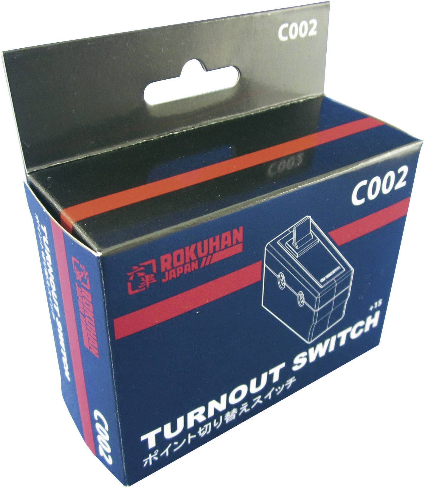 Černý obal s nápisem 'Turnout Switch C002' zobrazuje schematický obrázek spínače.