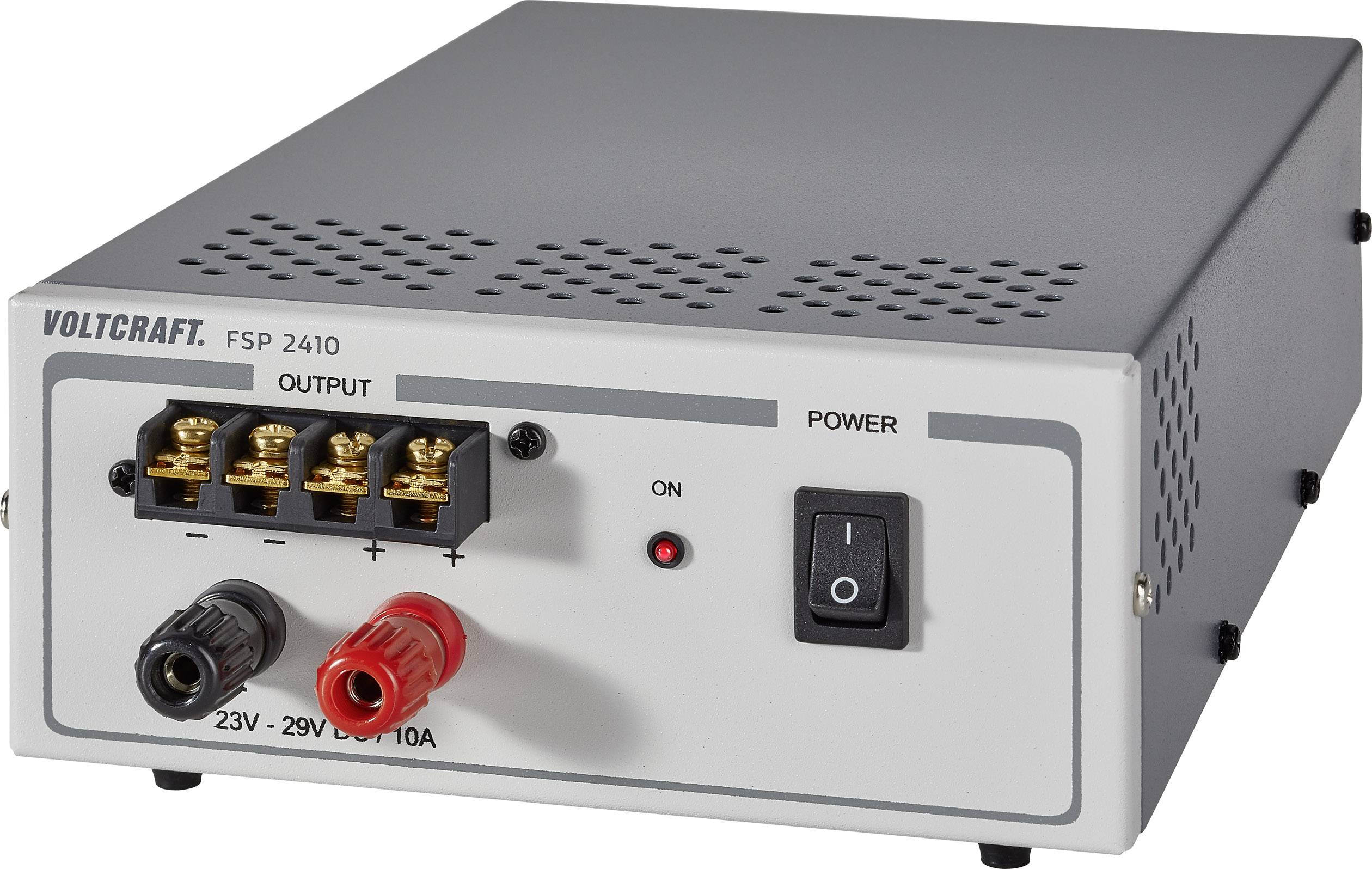 Šedý zdroj stejnosměrného proudu s nápisem 'VOLTCRAFT FSP 2410'. Má přípojky pro výstup proudu a vypínač zapnuto/vypnuto.