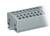 Šedý, obdélníkový plastový blok s několika vertikálními štěrbinami, pravděpodobně elektrický připojovací blok.