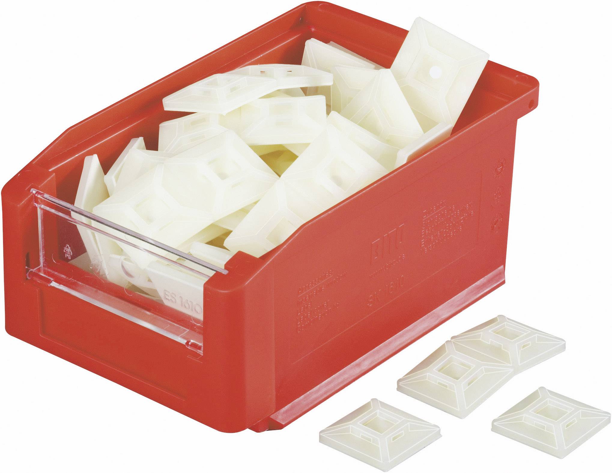 Červený třídící box s bílými plastovými díly. Některé díly leží mimo box.