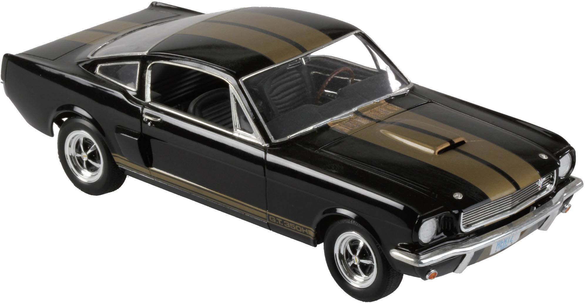 Černé modelové auto se zlatými pruhy, pohled z boku. Klasický design s červenými detaily v interiéru.