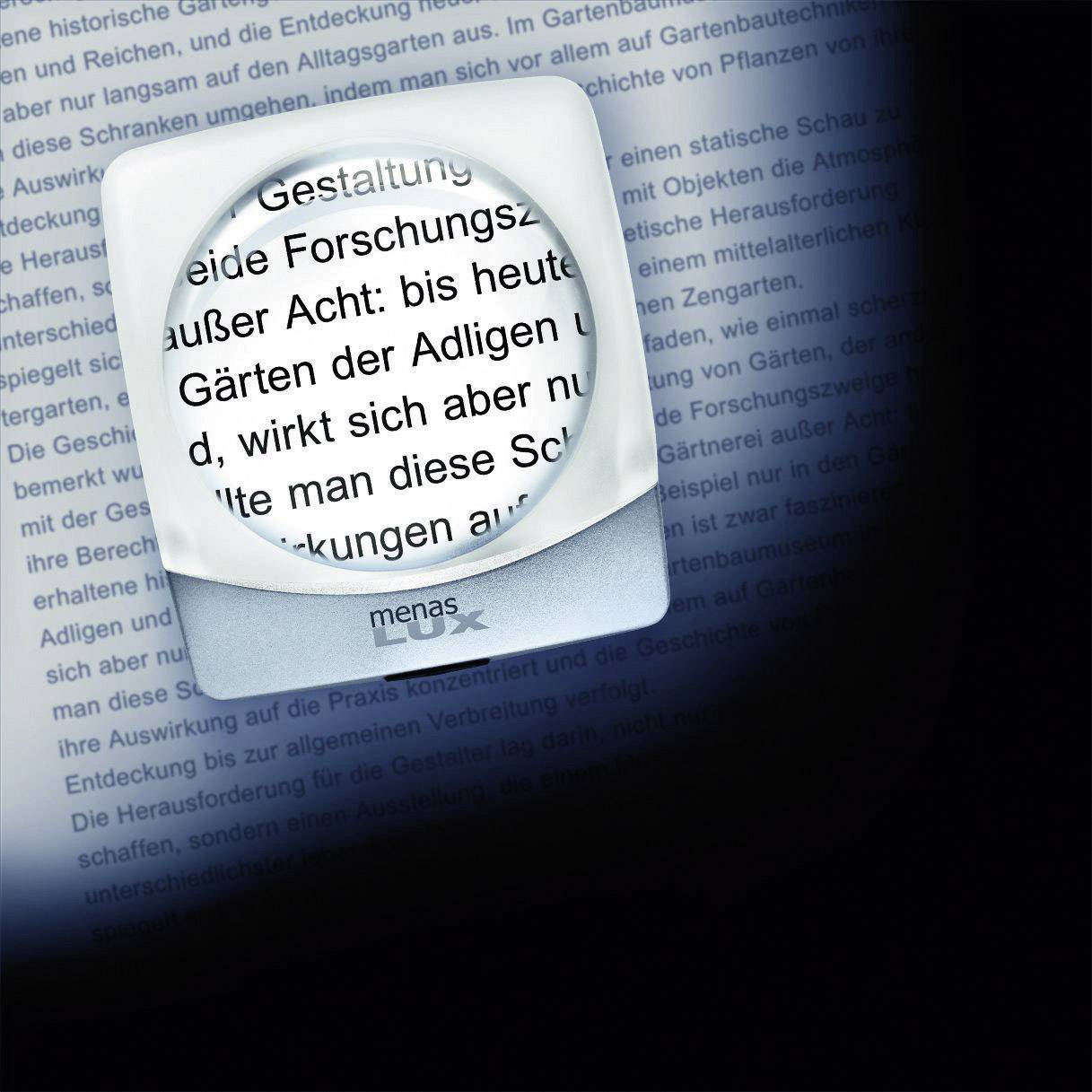 Lupa zvětšuje textový úsek na stránce. Text pojednává o designu, výzkumu a historických aspektech.