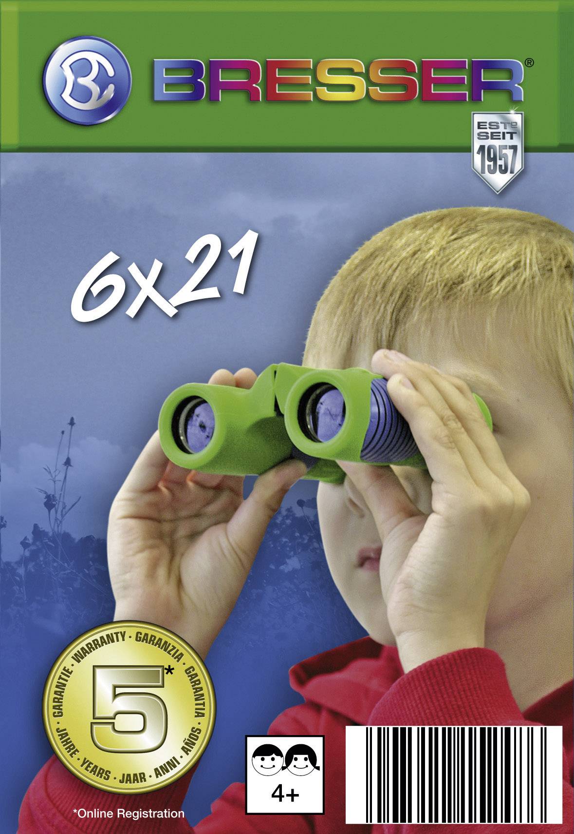 Chlapec se dívá skrz zelený dalekohled. Nahoře logo 'BRESSER' barevnými písmeny, vedle něj 6x21. Zlatý symbol záruky dole.