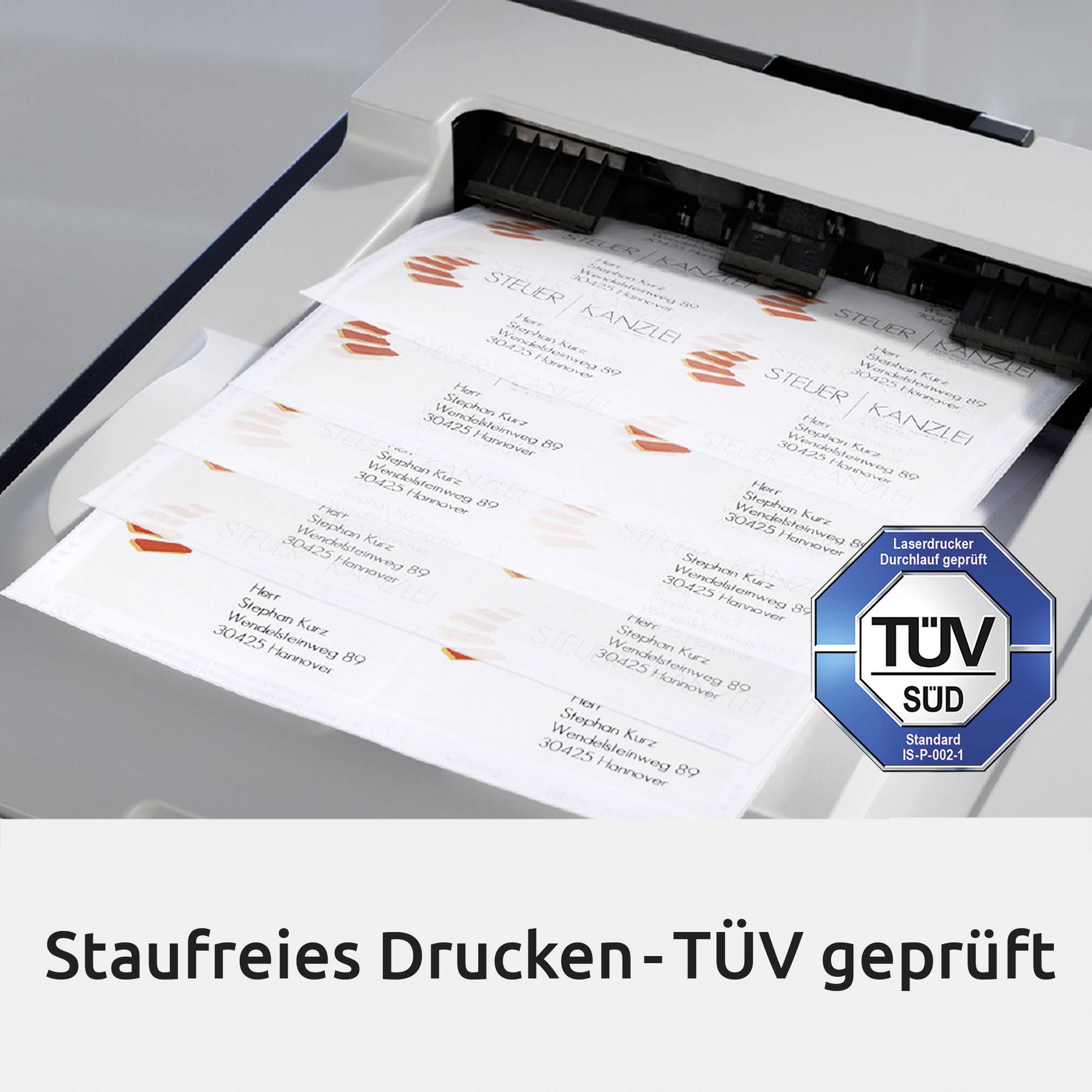 Printer med printede ark, hvor der står 'Støjfri udskrivning - TÜV certificeret'. Et TÜV-mærke er placeret på højre side.