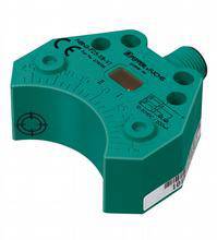 En rektangulær, grøn sensor med påtrykte markeringer og et rødt markeret område på oversiden.