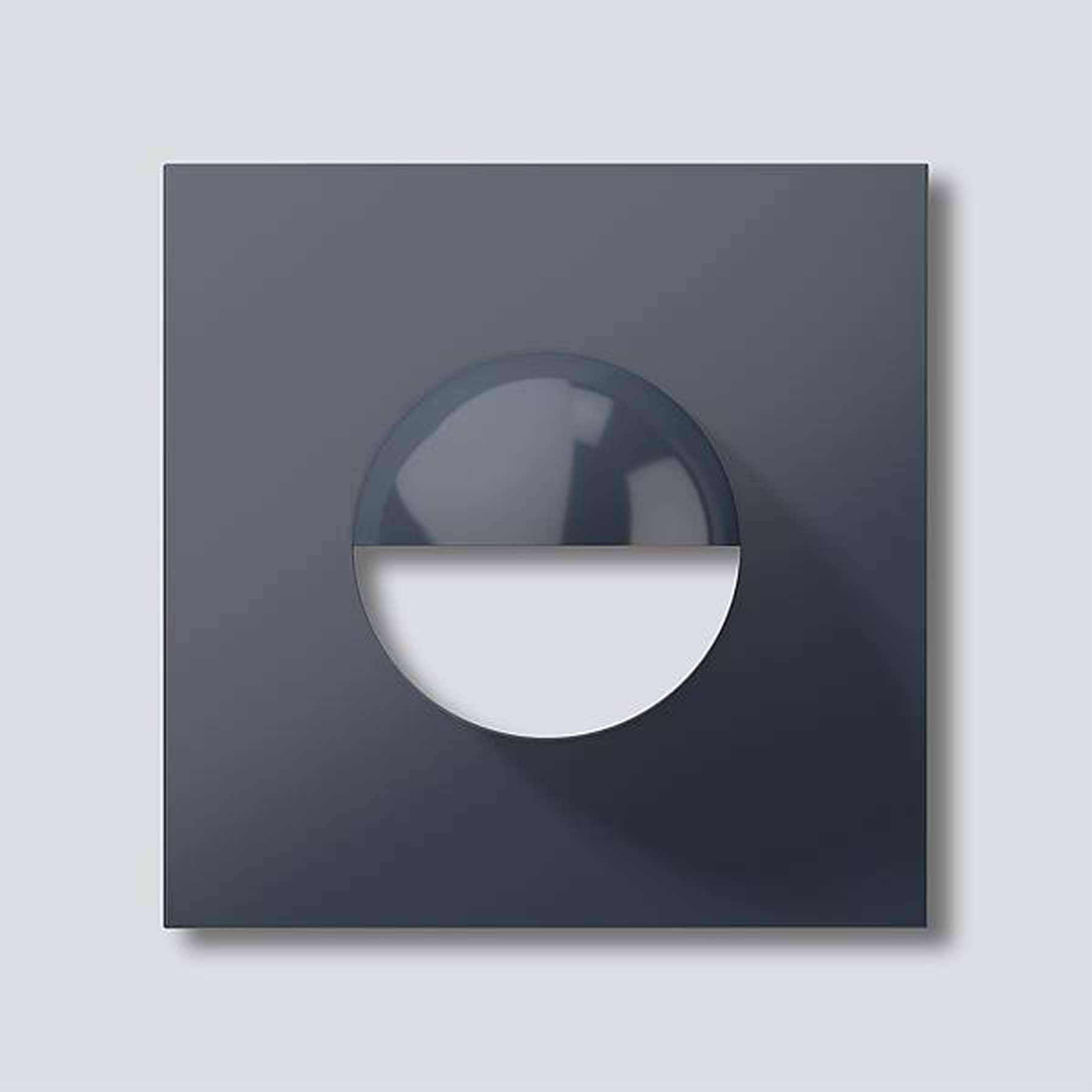 Mørkere, firkantet ramme med en rund, delvist udfyldt form i midten; minimalistisk, geometrisk design på en grå baggrund.