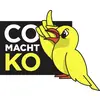 Sort logo med en gul tegneseriesfugl og ordene 'CO MACHT KO' i hvid og gul tekst.