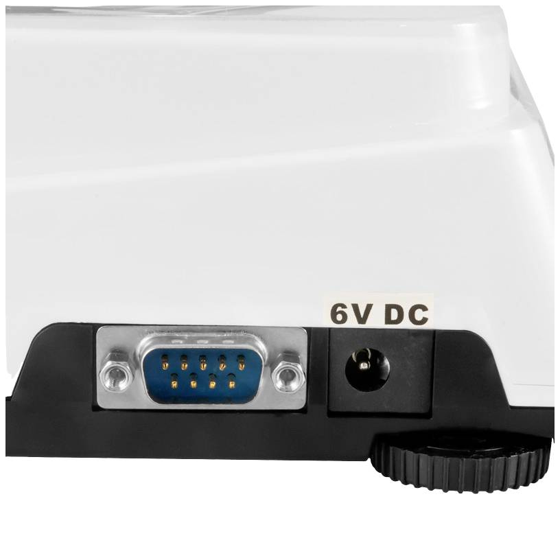 Nærbillede af en elektronisk enhed med et 6-bens stik, en DC-strømstik mærket '6V DC', og et riflet hjul.