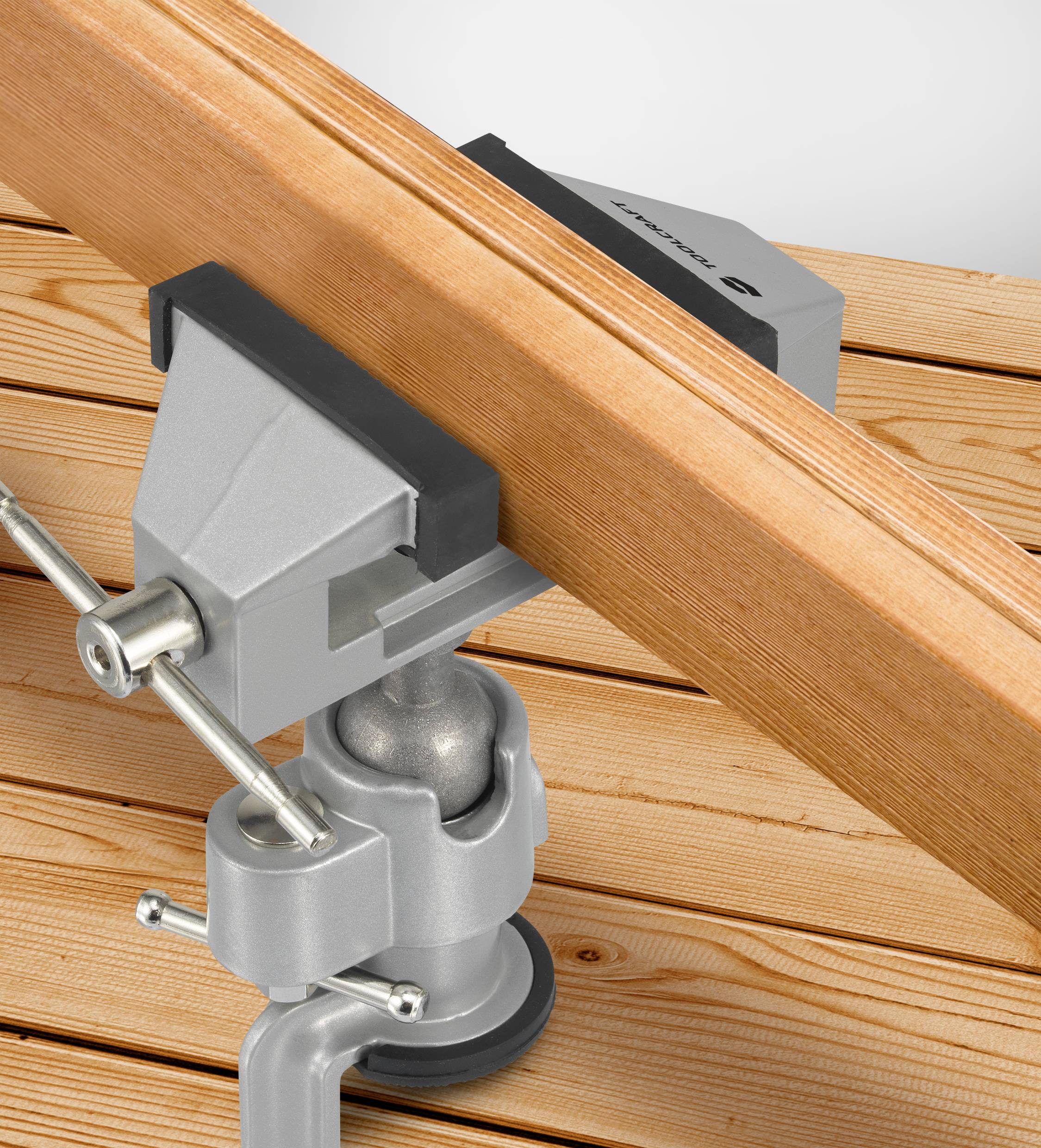 Klemmen holder et stykke træ fast på et bord. Perfekt til præcisionsopgaver eller bygningsprojekter.