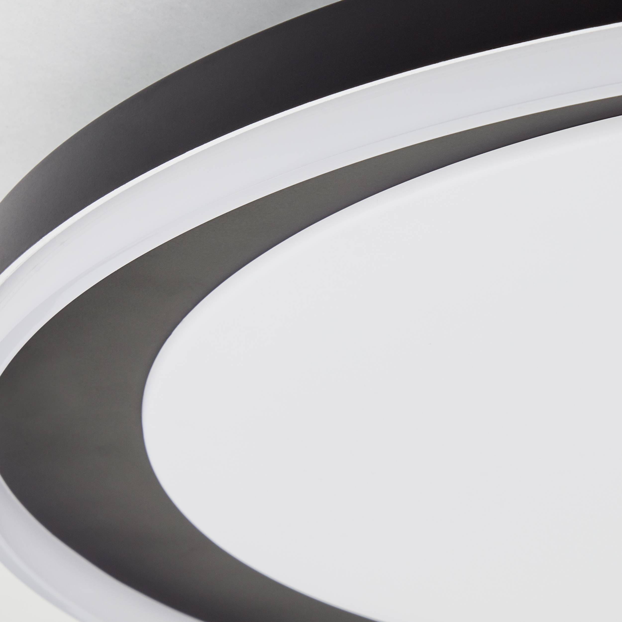 Tre overlappende hvide og grå elliptiske ringe på en hvid baggrund danner et minimalistisk, abstrakt design.