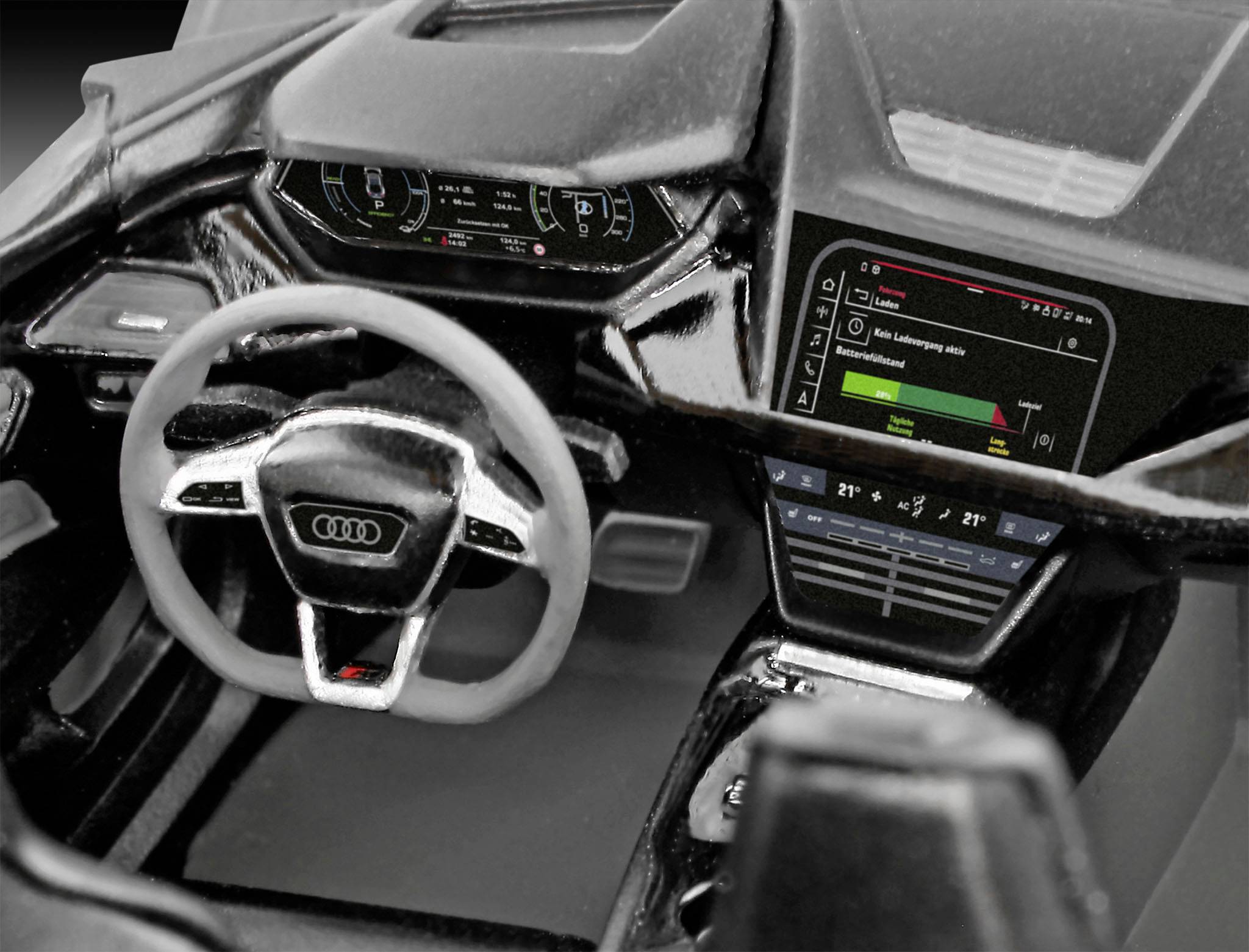 Billedet viser interiøret i en Audi bil med rat og digitale displayskærme. Forskellige knapper og indikatorer er synlige.