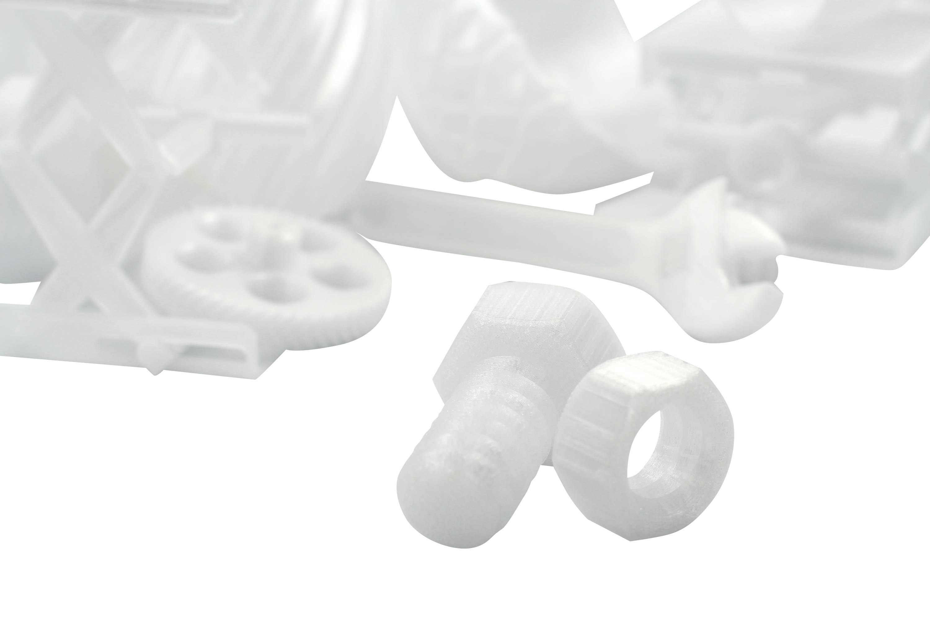 Hvide 3D-printede objekter: Skrue, møtrik, tandhjul, skruenøgle og diverse komponenter. De symboliserer teknologi og innovation.
