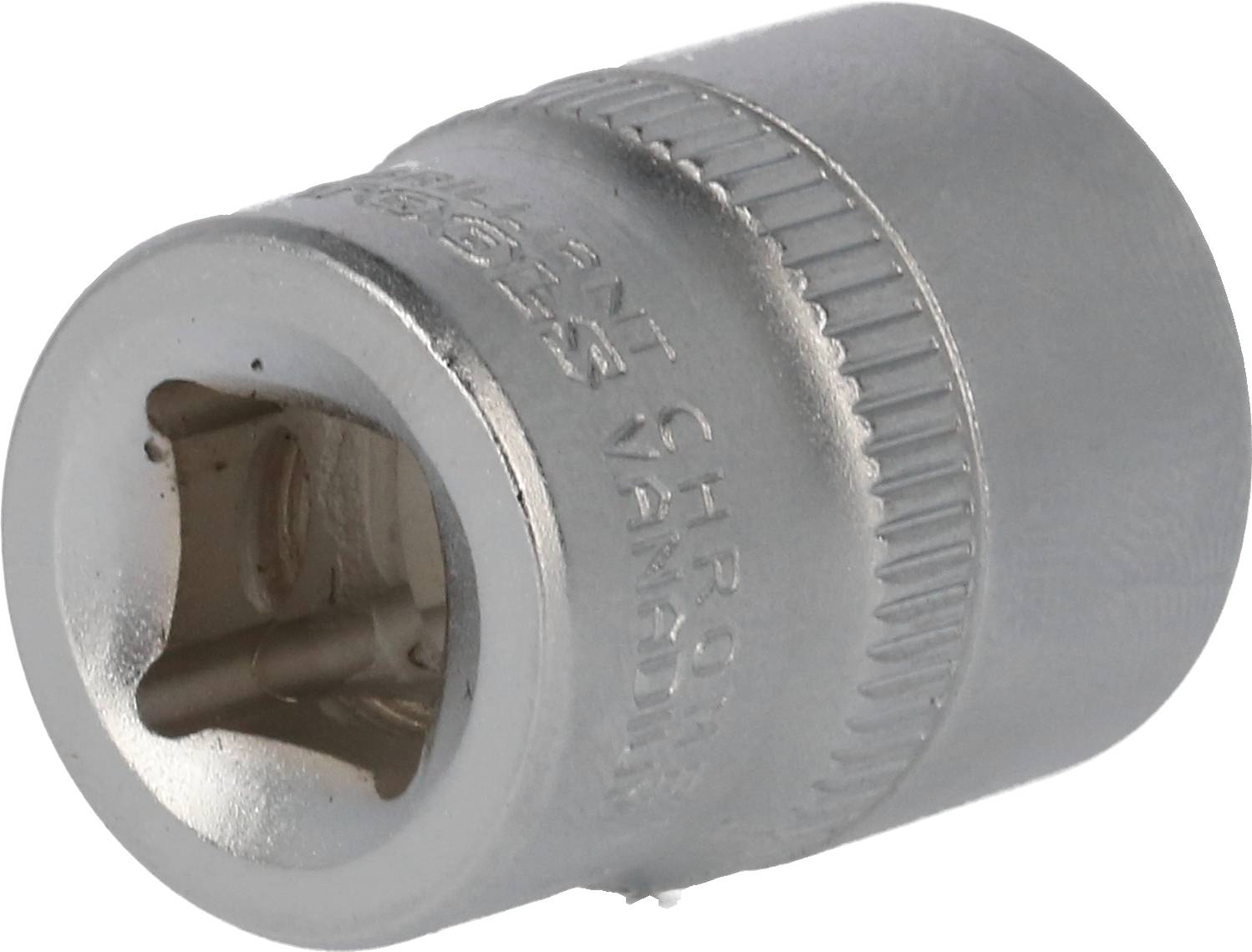 En sølv sokkel til unbrakonøgler, cylindrisk med sekskantede åbning, liggende på en metaloverflade.