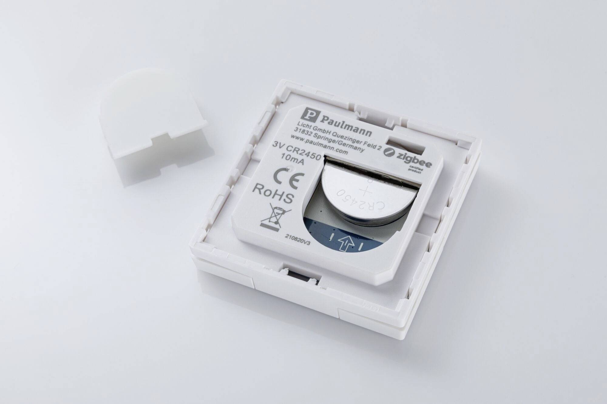 Batterirummet med åben afdækning viser et indsat 3V CR2450 batteri. Paulmann-logoet og tekniske specifikationer er synlige.