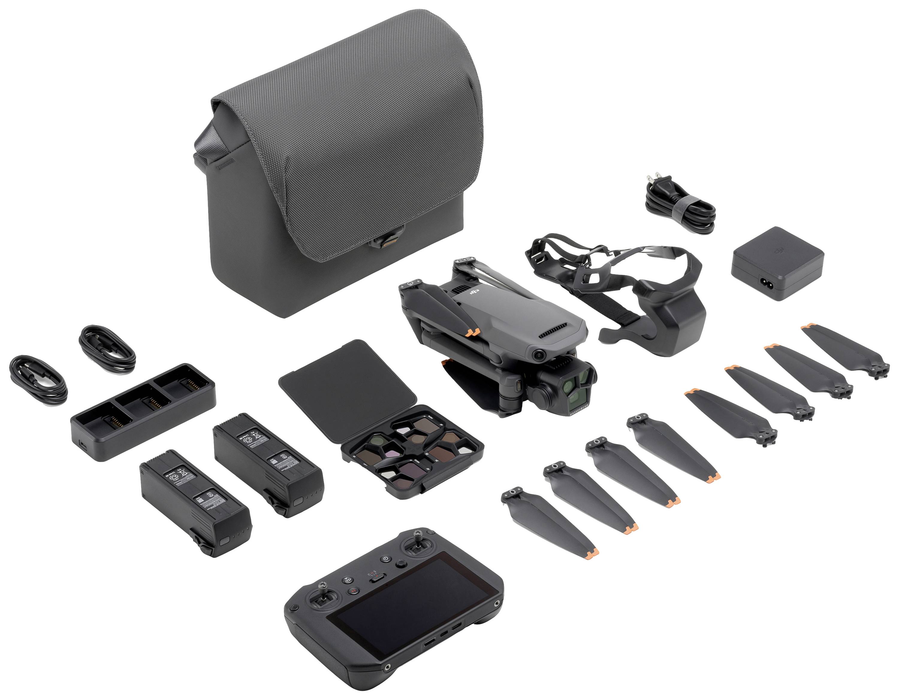 Drone-sæt med fjernbetjening, batterier, propeller, oplader og bæretaske. Kompakt design, velegnet til foto og videooptagelser.