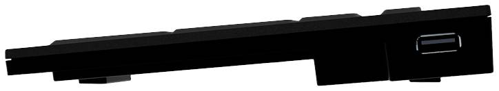 Et sort computer- eller laptoptastatur set fra siden, viser en tynd, retvinklet profil og et lavt tastaturlayout.