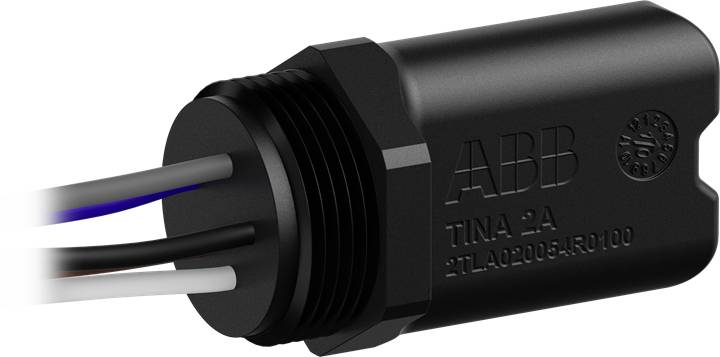 Elektrisk komponent fra ABB, model 'TINA-2A', cylinderformet, flere ledninger stikker ud fra den ene ende.
