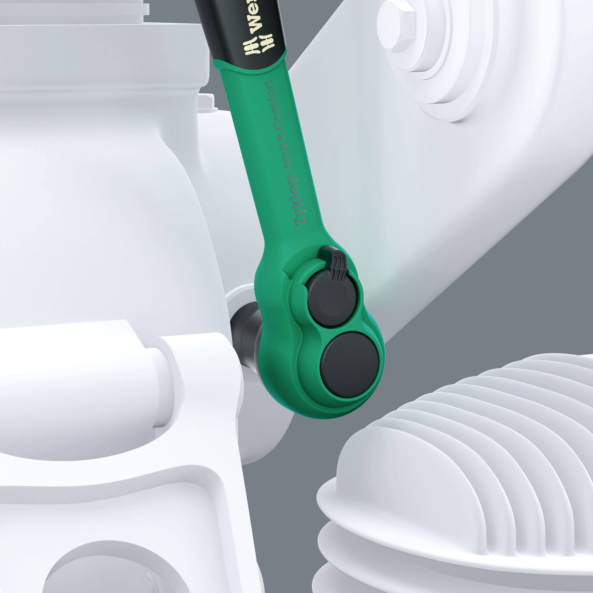 Et grønt værktøj, der ligger på en mekanisk del, sandsynligvis en skruenøgle. Værktøjets detaljer og baggrund er slørede.