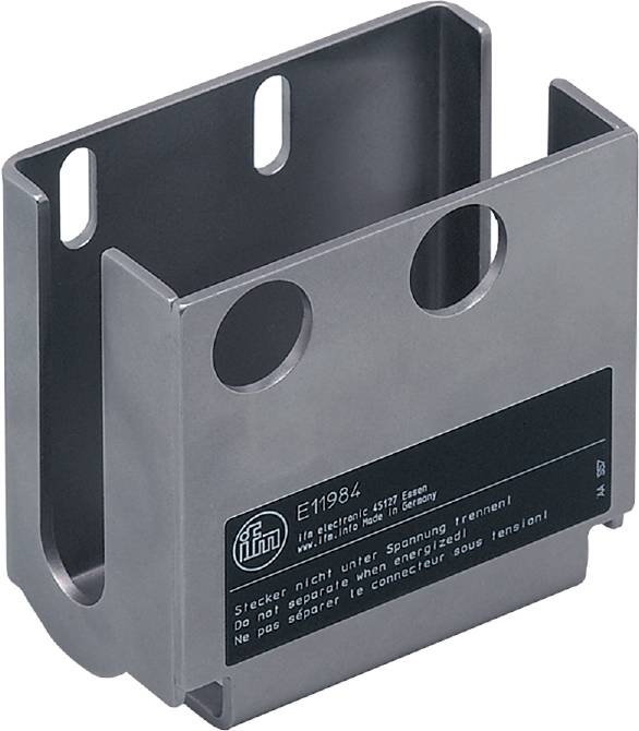 En metalgenstand med to huller og en mærkat, hvorpå der er sikkerhedsadvarsler på flere sprog.