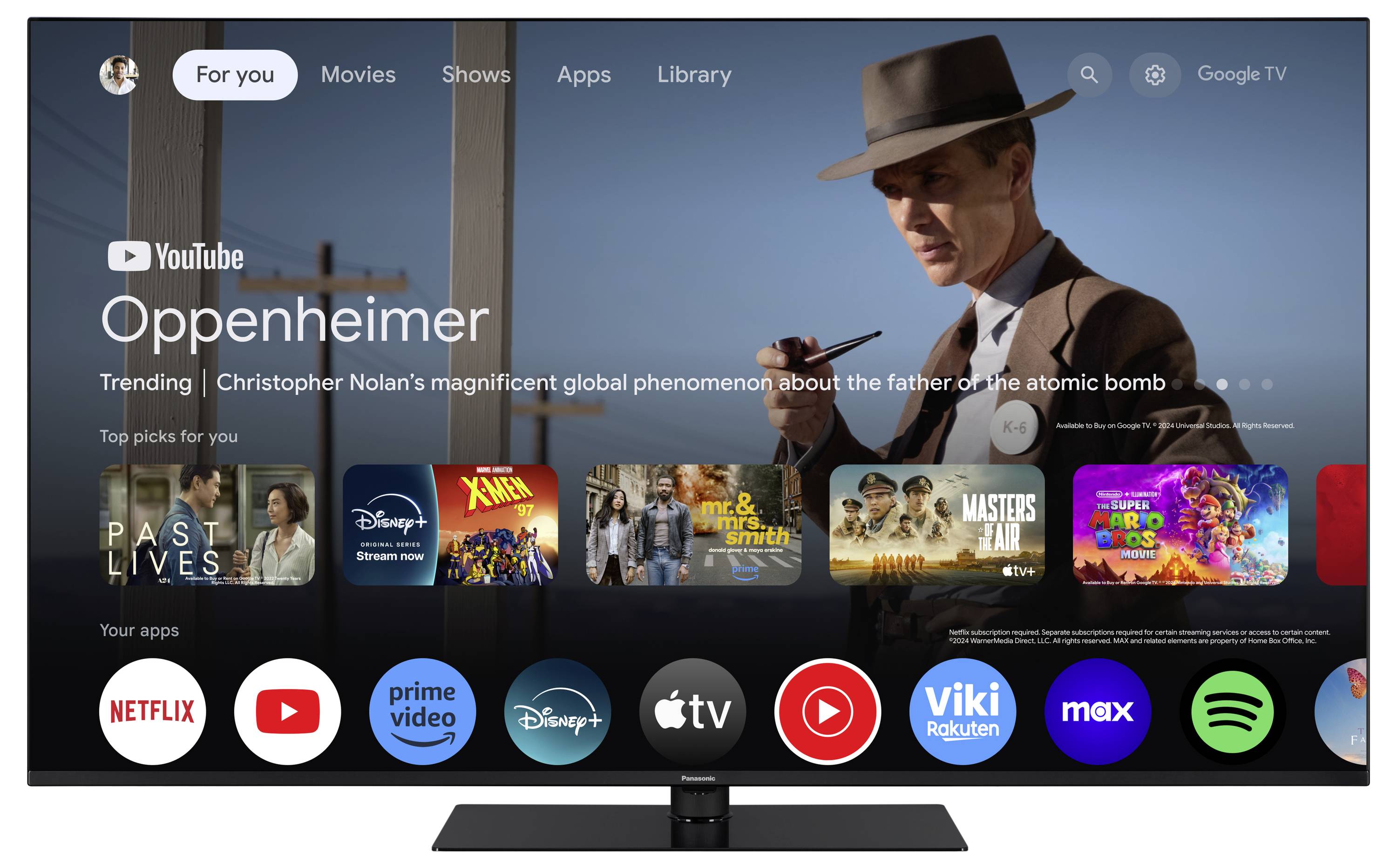 En fjernsyn viser startskærmen på en streaming-platform. 'Oppenheimer' fremhæves som en trending video, med film- og app-ikoner nedenunder.