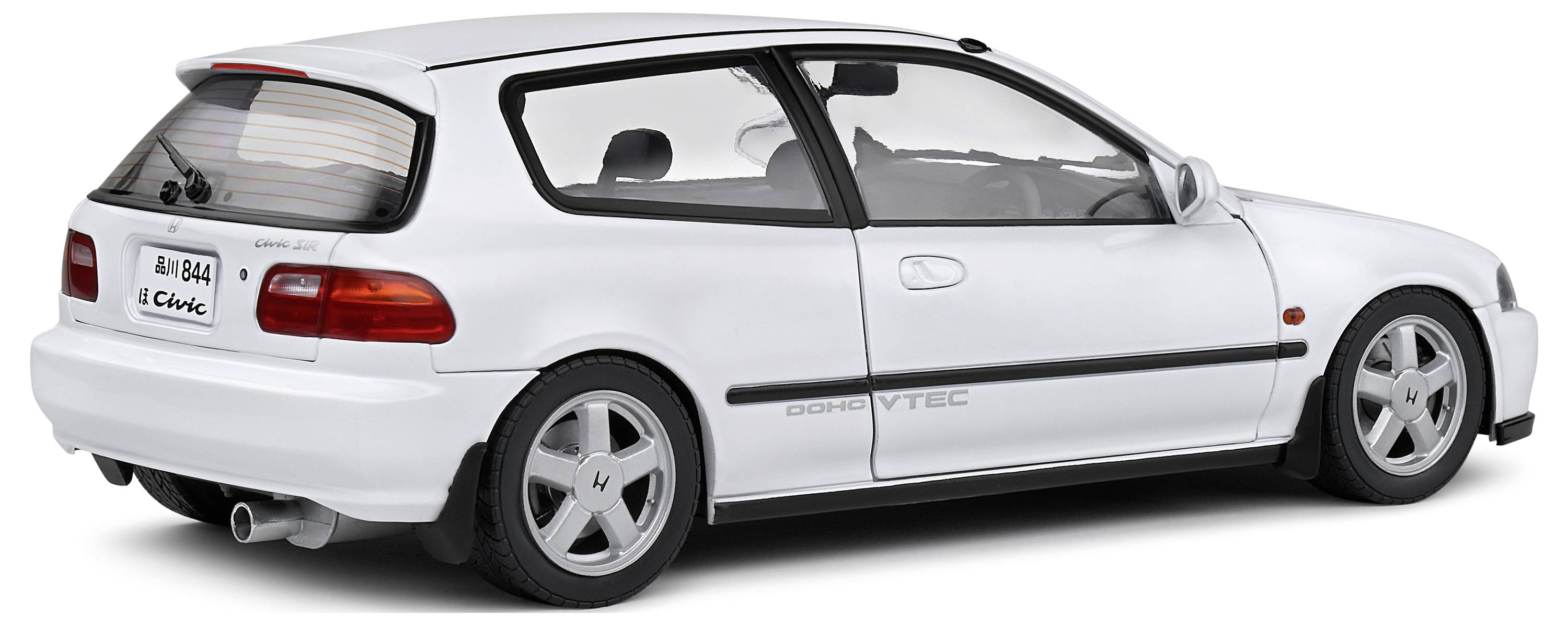 Hvid, sporty kompaktbil med hækspoiler. Model af Honda Civic med DOHC VTEC-motor.