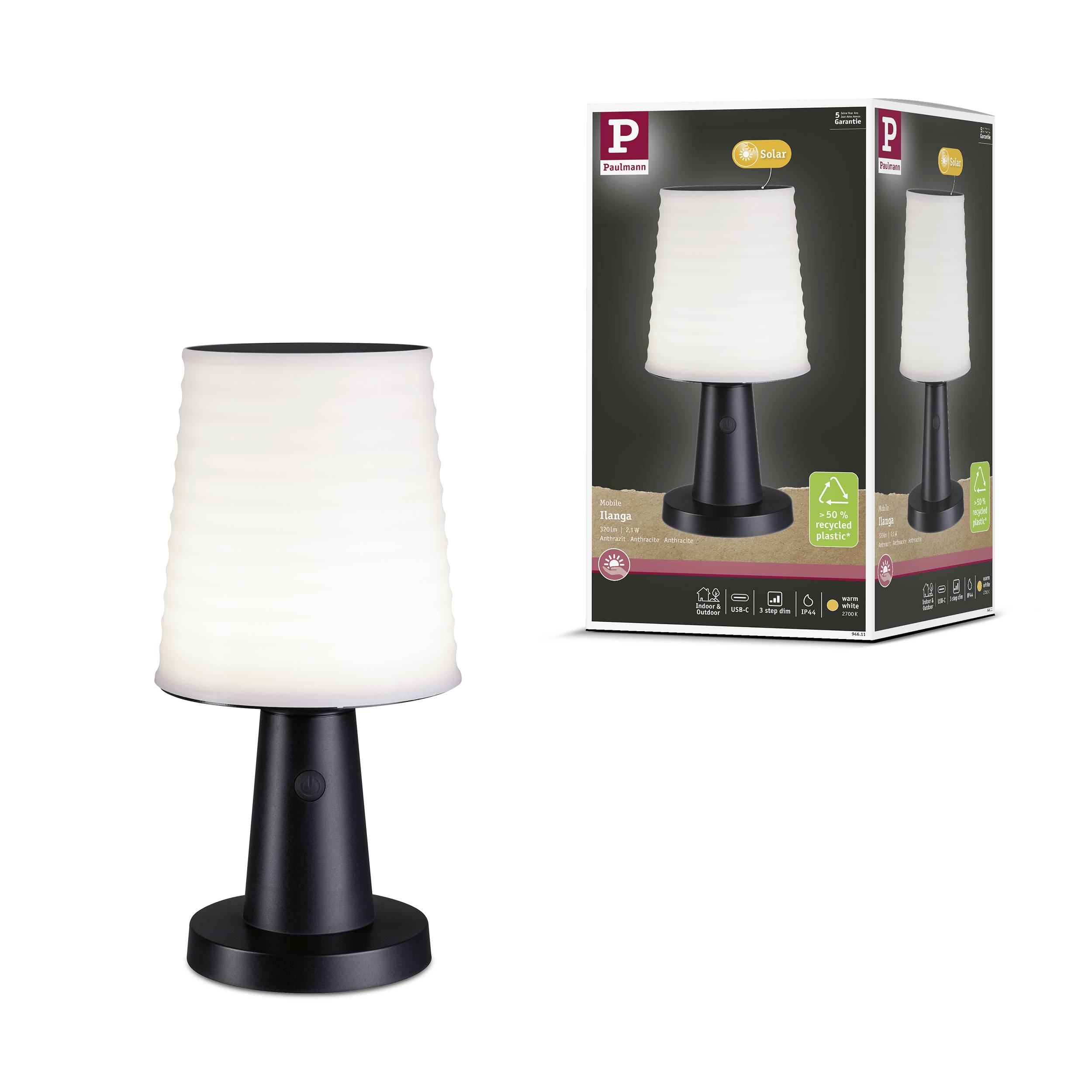 'Bordlampe med hvid skærm og sort base, ved siden af emballagen med samme billede og produktbeskrivelse.'