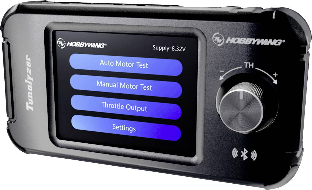 En sort elektronisk enhed med display, der viser fire valgmuligheder: 'Automatisk Motortest', 'Manuel Motortest', 'Gasudgang', 'Indstillinger'. En drejeknap og Bluetooth-symbol er synlige.