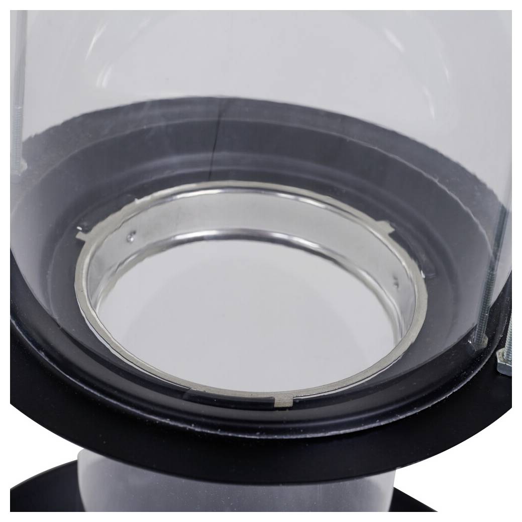 Nærbillede af en ren, transparent glaskontainer med en metalrand, set fra oven, der viser dens cirkulære åbning og reflekterende overflade.