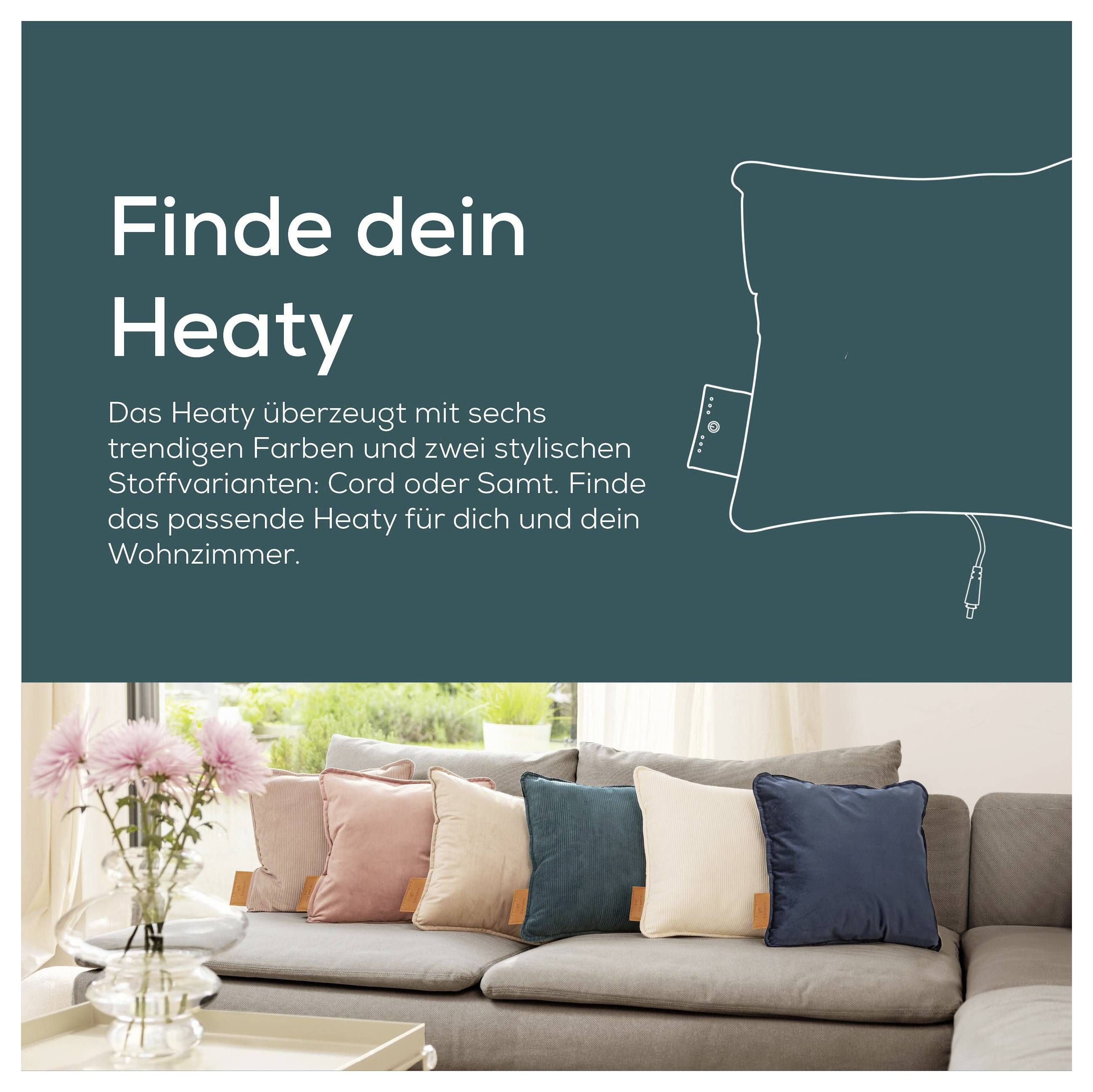 'Find din Heaty' skrevet over et billede af et gemytligt stuerum med farverige puder på en sofa, der promoverer stilfulde varmehoveder.