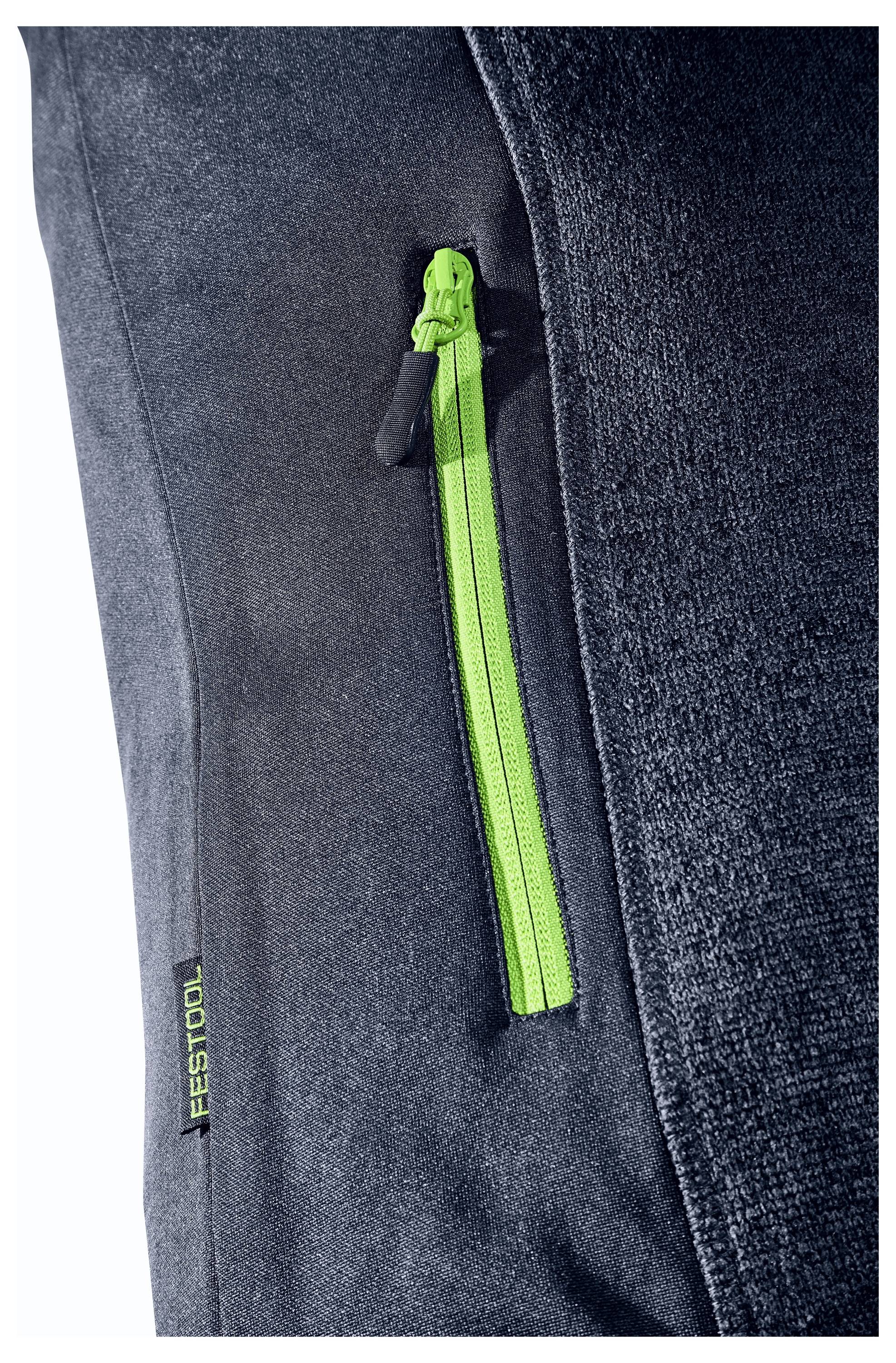 Tætoptagelse af en sort stofftaske med en lysegrøn lynlås og "Festool"-etiket på siden.