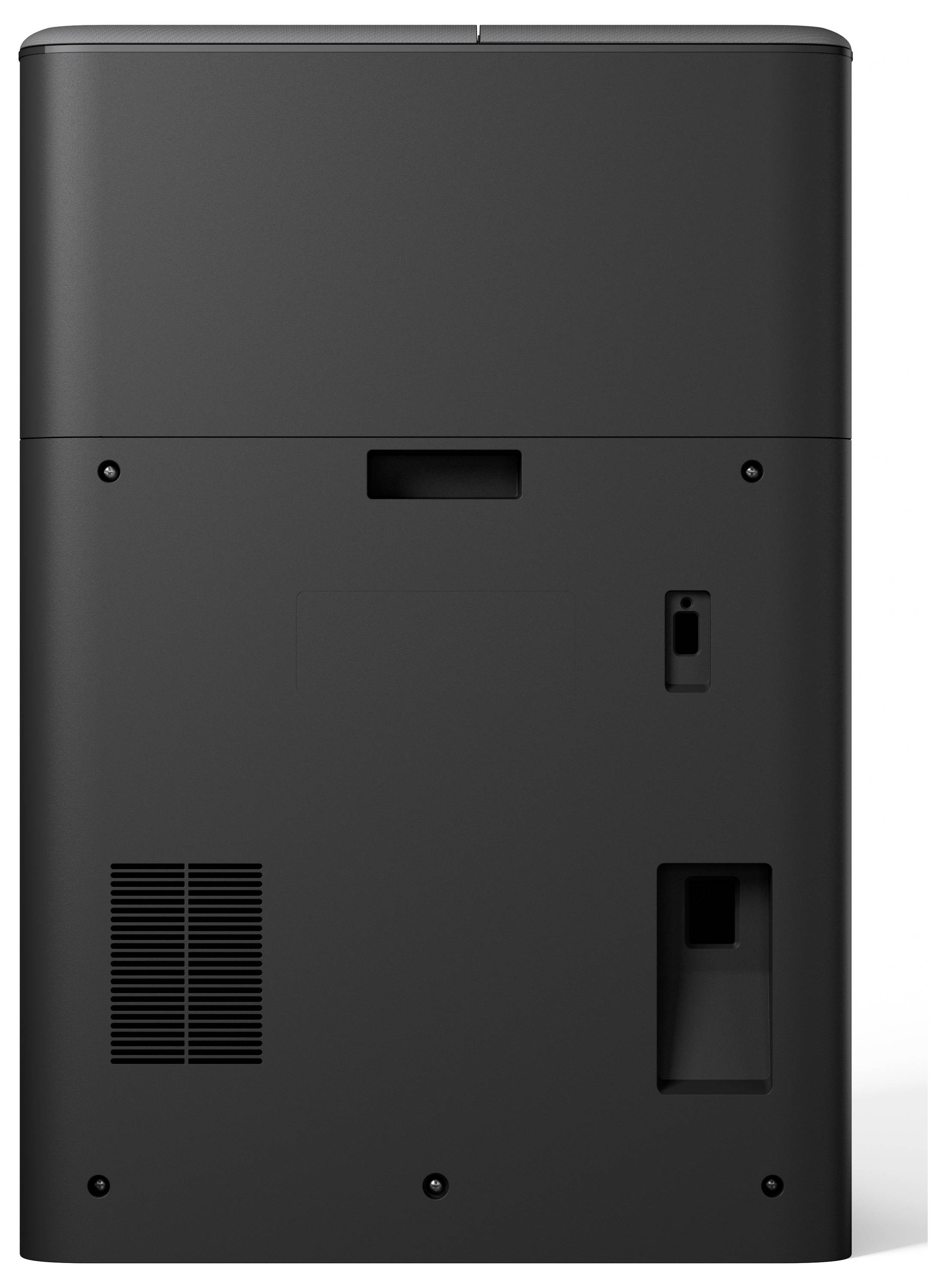 'Bagside af en sort elektronisk enhed med ventilation, spalter og forbindelsesporte. Simpelt, minimalistisk design, sandsynligvis et husholdningsapparat.'