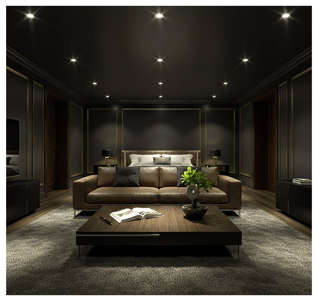 Moderne soveværelse med en brun lædersofa, sofabord med en åben bog, seng i baggrunden og svag indirekte belysning i et mørkt, elegant interiør.