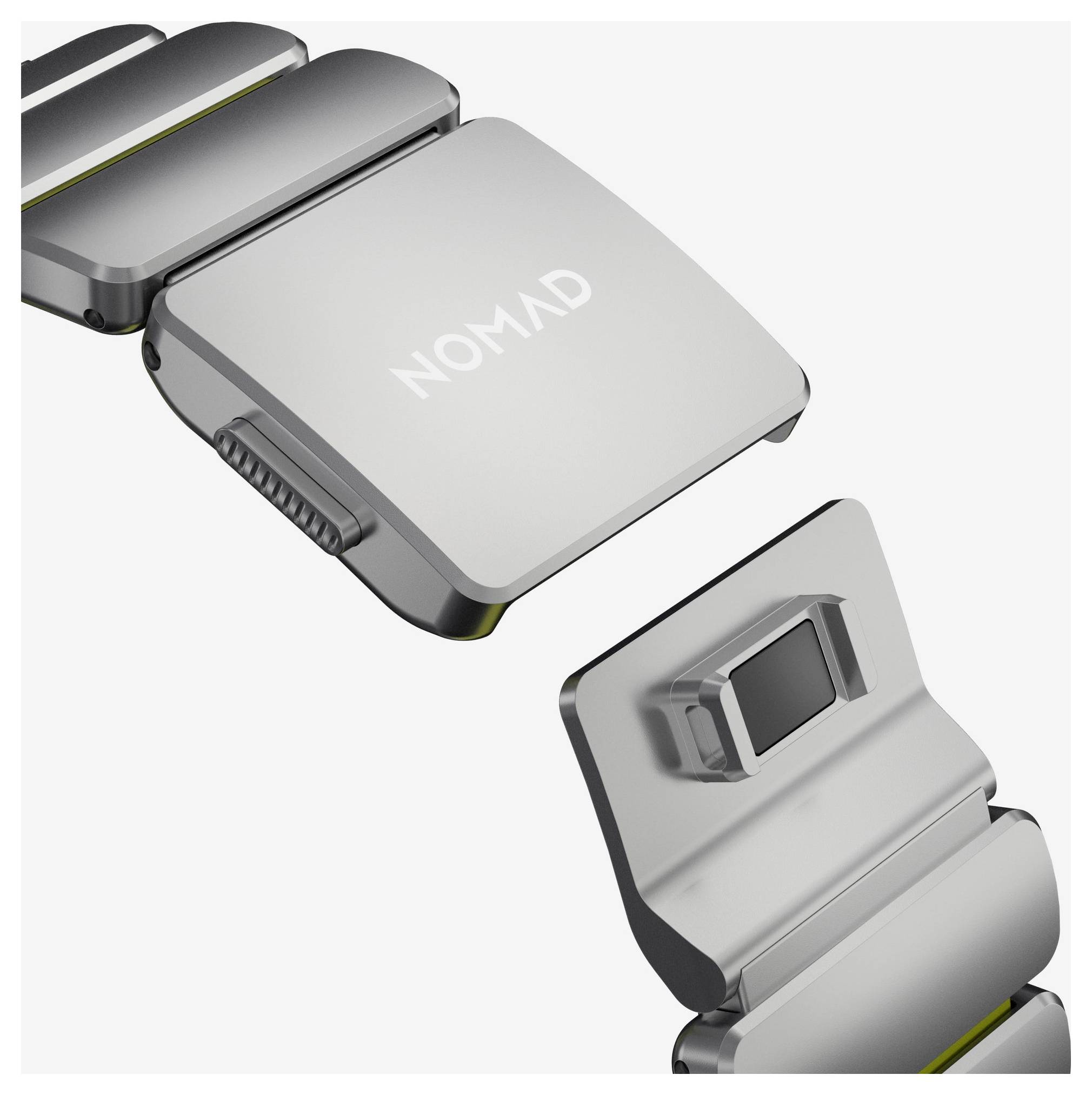 Tæt billede af en grå NOMAD foldbar metalenhed, vist åben i flere hængslede sektioner på hvid baggrund.
