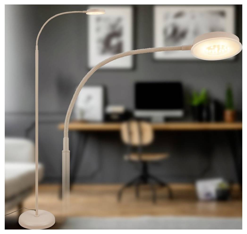 To justerbare gulvlamper lyser op i et hjemmekontor med et skrivebord, computer, stol og indrammet vægkunst i baggrunden.