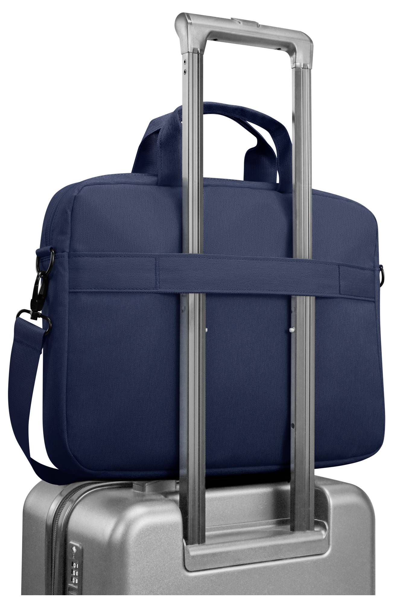 Blå håndbagage fastgjort på det udvidede håndtag på en sølvfarvet kuffert, vist mod en hvid baggrund.