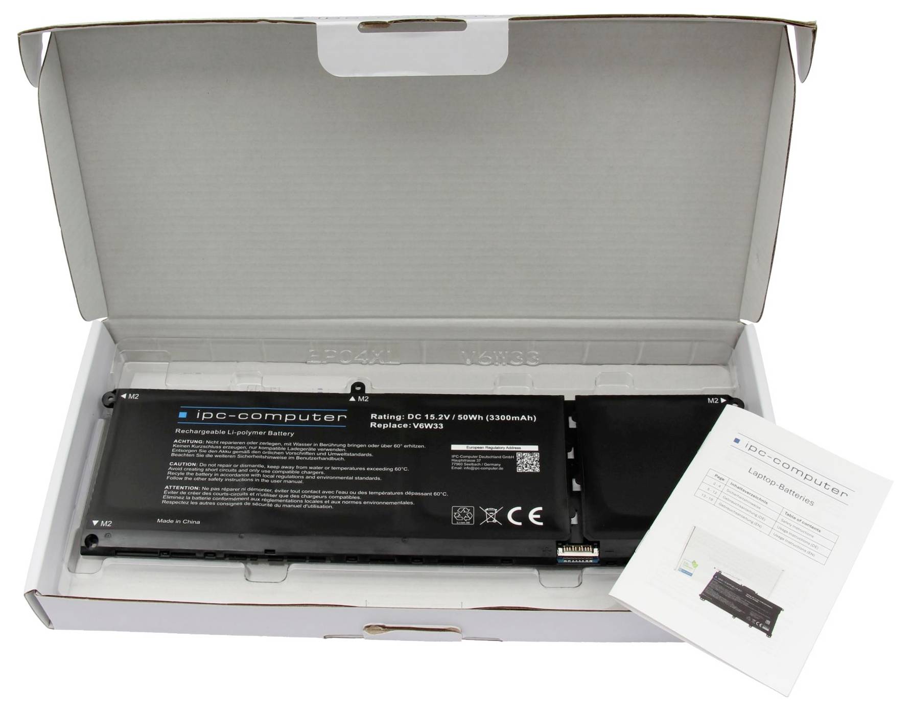 Åben paptæske indeholdende et sort IPC-computerbar batteri og en foldet instruktionsbroschure.
