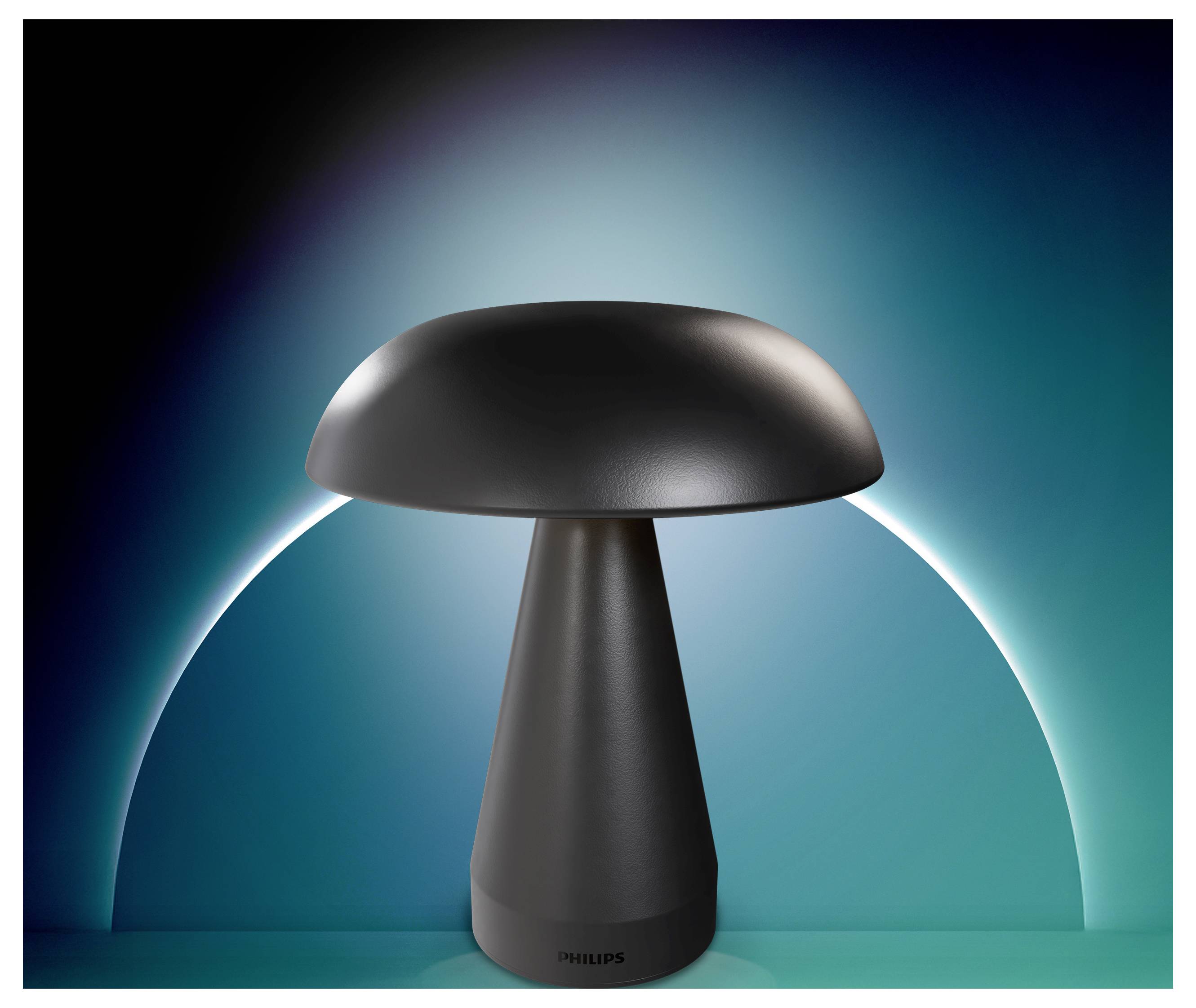 En moderne sort svampeformet lampe centreret mod en blågrøn glødende baggrund med en hvid bue bag den.