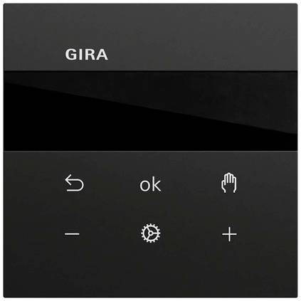 Sort GIRA vægkontrolpanel med mørkt display og berøringsikonner til tilbage, ok, hånd, minus, indstillingsgear og plus.