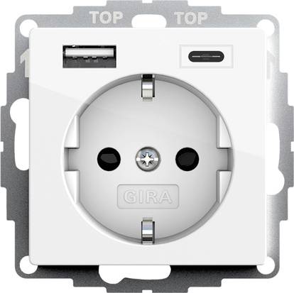 Hvid vægstik med USB-A og USB-C opladningsporte over et rundt europæisk stik.