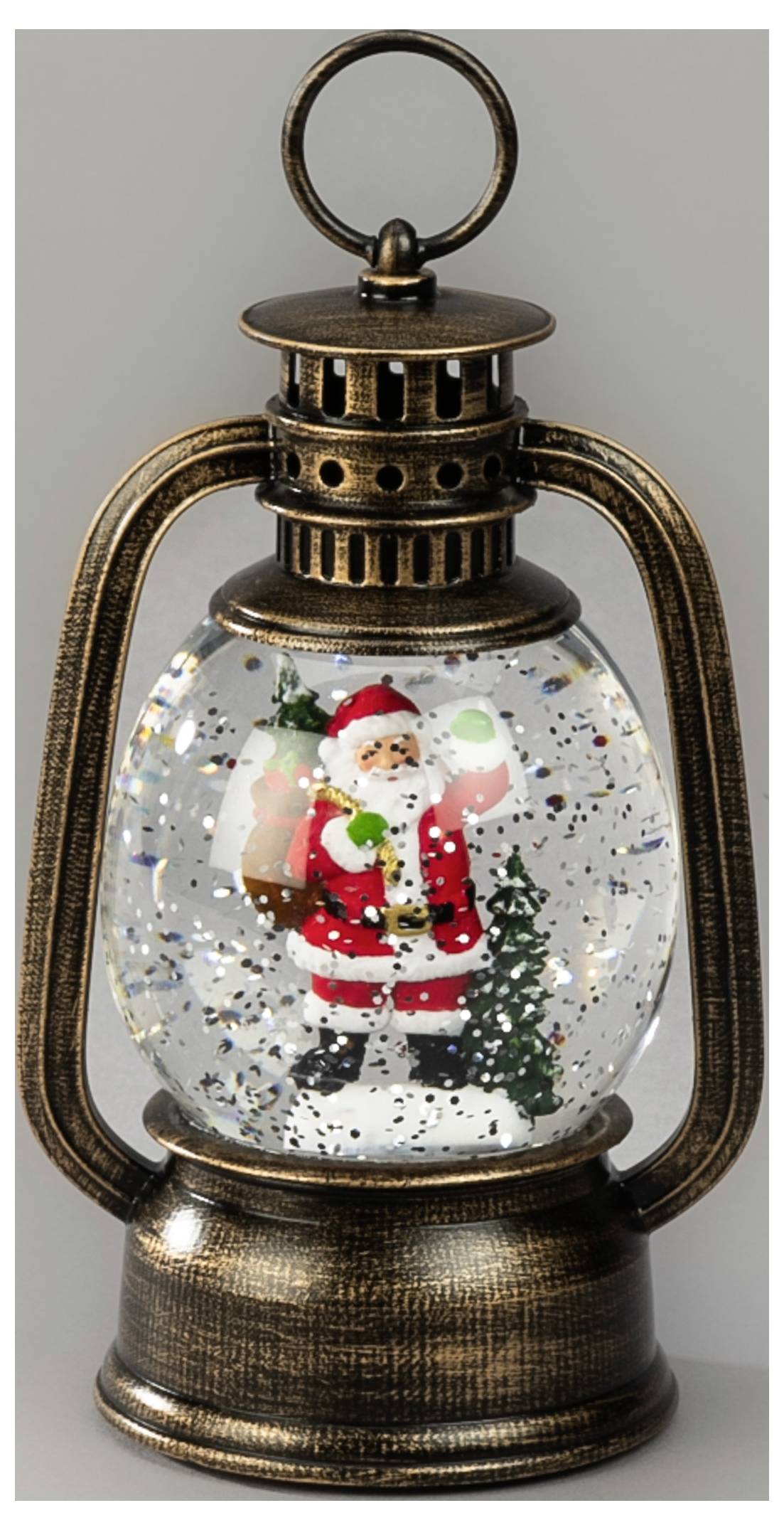 Dekorativ lykkebringerformet snekugle med Julemanden, et lille juletræ og glitter inden i en bronzefarvet ramme.