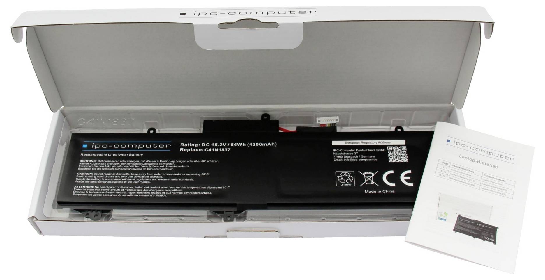Åbnet kasse, der viser en sort ipC-computerbatteripakning med instruktionsvejledning ved siden af den.