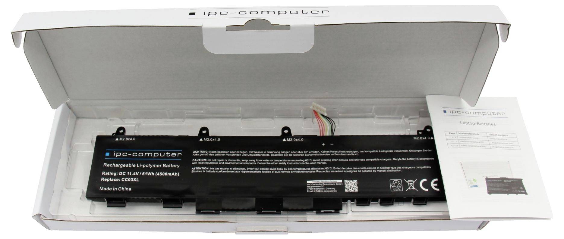 En iPo-computeribatteri-pakke i en hvid detailboks, med et sort erstatningsbatteri og et instruktionsark synligt inde i den åbne emballage.