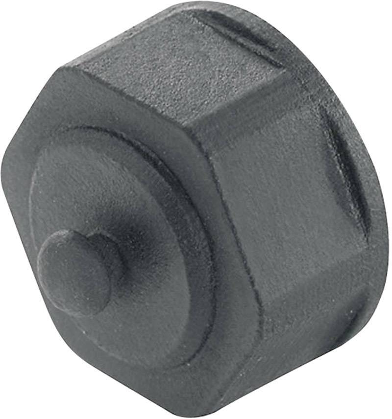Sort, ottekant plastikhovede med en lille, cylindrisk fremspring i midten. Bruges til mekaniske enheder eller låse.